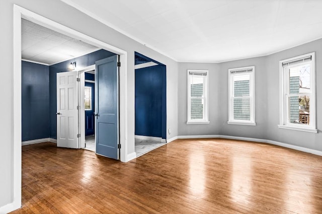 319 60th Ave W, Duluth, MN 55807 - unfurnished room featuring ornamental molding, wood finished floors, plenty of natural light, and baseboards