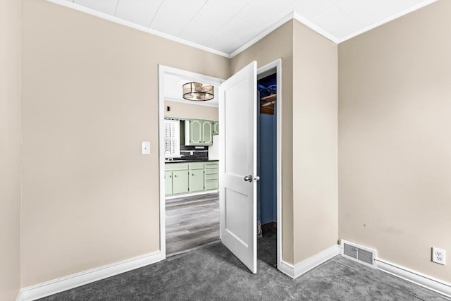 319 60th Ave W, Duluth, MN 55807 - unfurnished bedroom featuring crown molding, dark carpet, a sink, and baseboards
