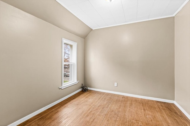 319 60th Ave W, Duluth, MN 55807 - unfurnished room featuring baseboards, light wood-style flooring, ornamental molding, and lofted ceiling