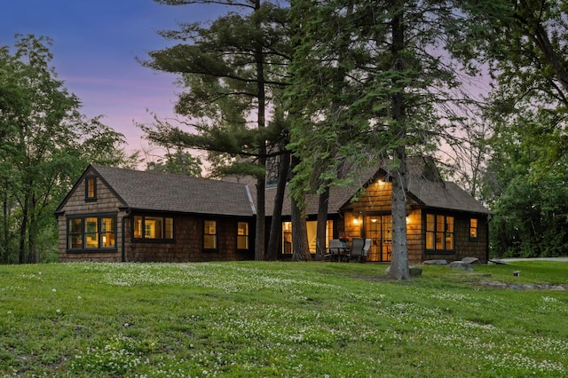 605 Stubbs Bay Rd, Orono, MN 55356 - back of house at dusk featuring a lawn