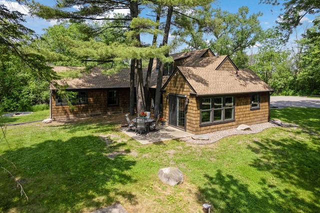 605 Stubbs Bay Rd, Orono, MN 55356 - rear view of property with roof with shingles, a patio area, and a lawn