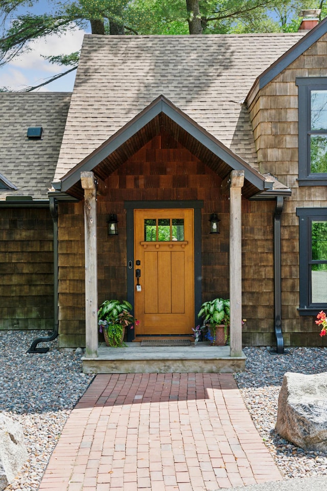 605 Stubbs Bay Rd, Orono, MN 55356 - entrance to property featuring roof with shingles and a porch