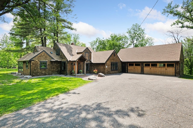 605 Stubbs Bay Rd, Orono, MN 55356 - shingle-style home featuring driveway, a chimney, an attached garage, and a front lawn