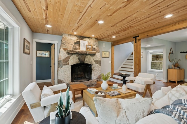 605 Stubbs Bay Rd, Orono, MN 55356 - living room featuring wooden ceiling, recessed lighting, stairway, baseboards, and a stone fireplace
