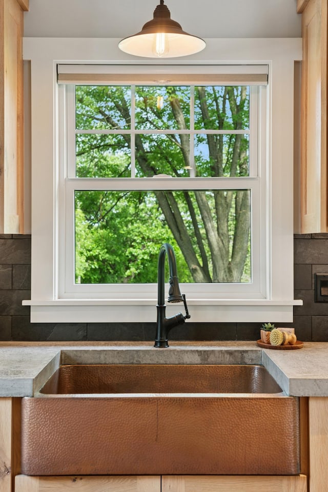 605 Stubbs Bay Rd, Orono, MN 55356 - kitchen view of a sink, tasteful backsplash, decorative light fixtures, and light countertops
