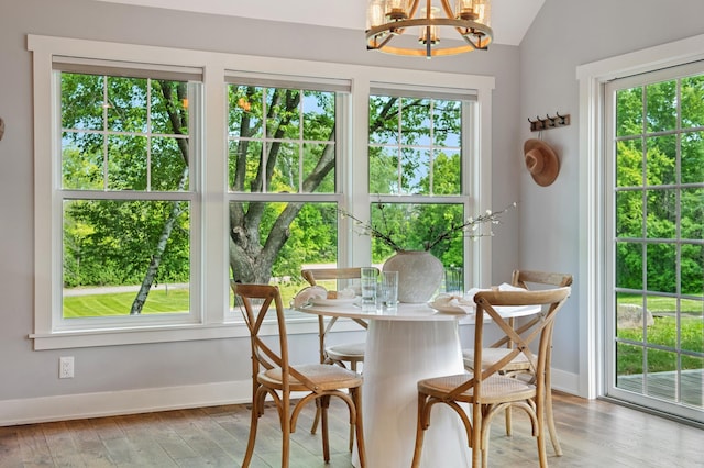 605 Stubbs Bay Rd, Orono, MN 55356 - dining space featuring a chandelier, wood finished floors, baseboards, and lofted ceiling