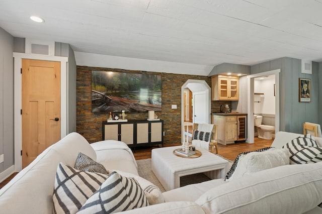 605 Stubbs Bay Rd, Orono, MN 55356 - living room with beverage cooler, light wood-style flooring, and arched walkways