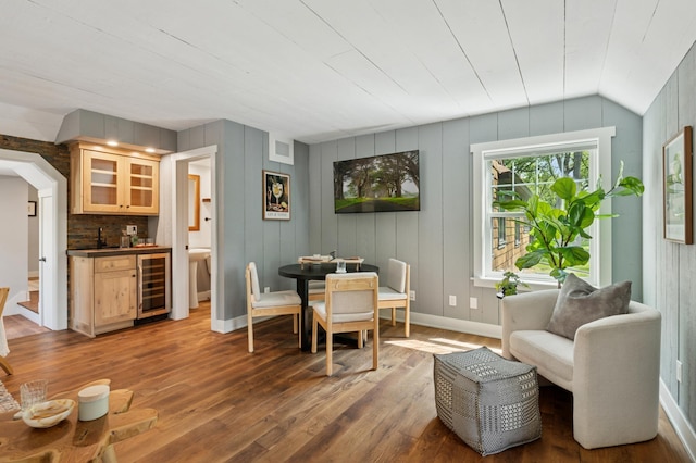 605 Stubbs Bay Rd, Orono, MN 55356 - dining space with beverage cooler, bar with sink, wood-type flooring, lofted ceiling, and baseboards