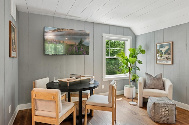 605 Stubbs Bay Rd, Orono, MN 55356 - dining space featuring wood finished floors, wood walls, lofted ceiling, and baseboards