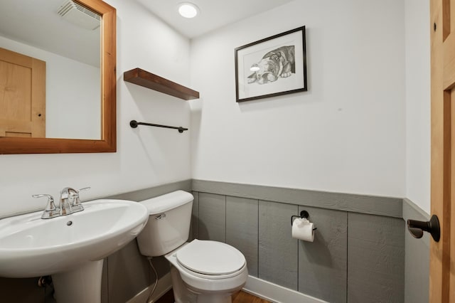 605 Stubbs Bay Rd, Orono, MN 55356 - bathroom with toilet, wainscoting, and a sink