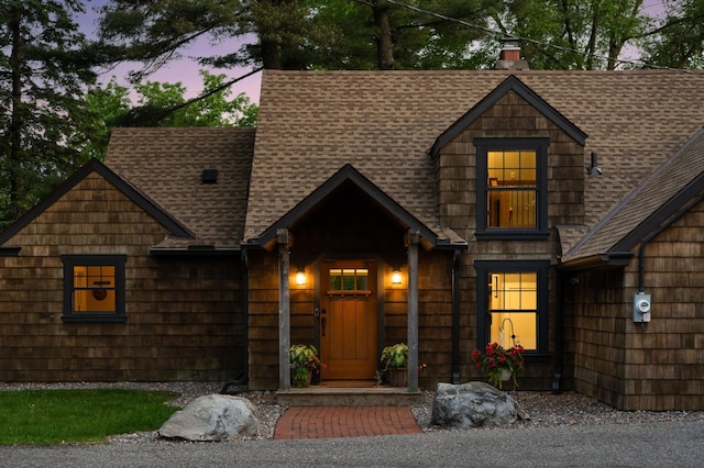 605 Stubbs Bay Rd, Orono, MN 55356 - view of front of property with a shingled roof and a chimney