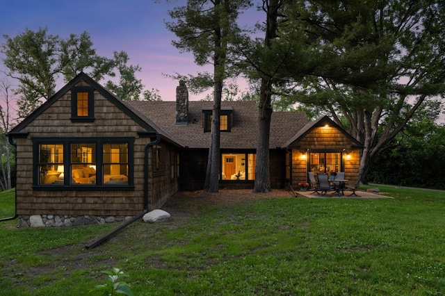 605 Stubbs Bay Rd, Orono, MN 55356 - back of property with a lawn, a chimney, and roof with shingles