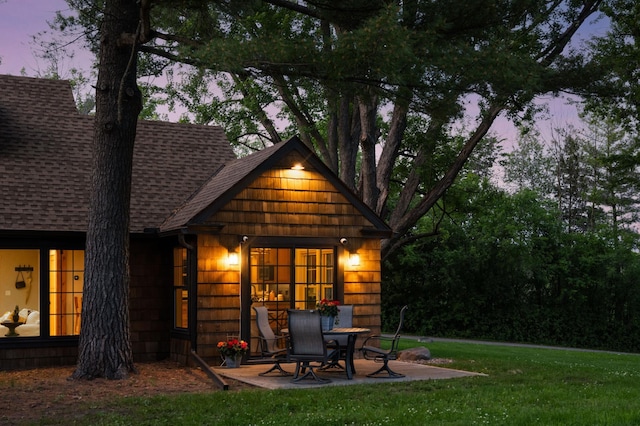 605 Stubbs Bay Rd, Orono, MN 55356 - rear view of property featuring roof with shingles, a patio area, and a yard
