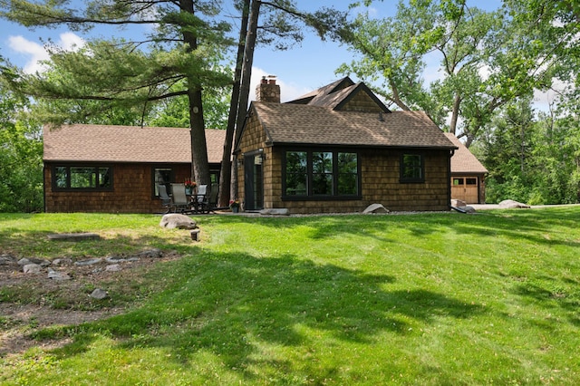 605 Stubbs Bay Rd, Orono, MN 55356 - back of house featuring a chimney, a yard, a garage, and a shingled roof