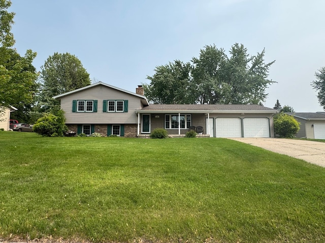 155 Outer Dr, Le Sueur, MN 56058 - split level home with an attached garage, driveway, a chimney, and a front yard