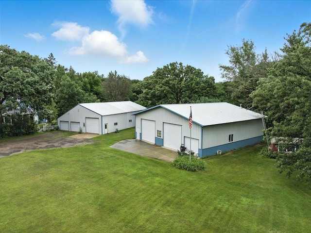 32166 Azure Rd, Scandia Valley Twp, MN 56443 - rear view of property featuring a detached garage, a yard, and an outdoor structure