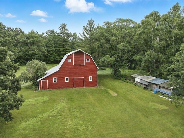 32166 Azure Rd, Scandia Valley Twp, MN 56443 - view of barn featuring a yard, a wooded view, and driveway