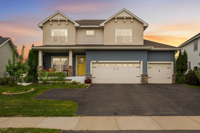 15239 Embry Path, Apple Valley, MN 55124 - craftsman house with stone siding, a porch, asphalt driveway, a lawn, and an attached garage