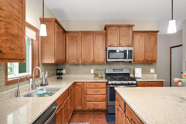 15239 Embry Path, Apple Valley, MN 55124 - kitchen with stainless steel appliances, a sink, brown cabinetry, dark wood-style flooring, and light stone countertops