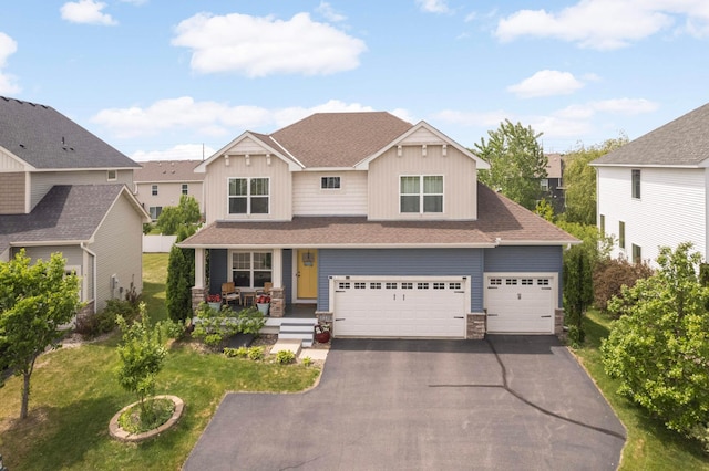 15239 Embry Path, Apple Valley, MN 55124 - craftsman-style house with a porch, driveway, a front yard, stone siding, and an attached garage