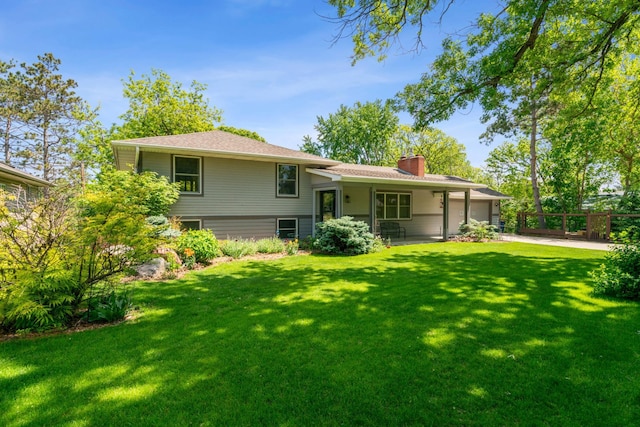 4716 Overlook Dr, Bloomington, MN 55437 - rear view of property featuring a garage, a chimney, and concrete driveway