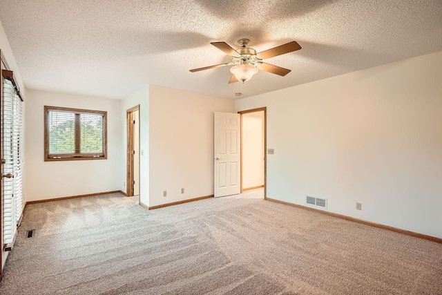 3544 166th Ln NW, Andover, MN 55304 - unfurnished bedroom with light colored carpet, a textured ceiling, baseboards, and ceiling fan