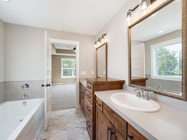 20713 Tamarack St NW, Oak Grove, MN 55011 - full bath featuring marble look tile flooring, vanity, a garden tub, and ceiling fan