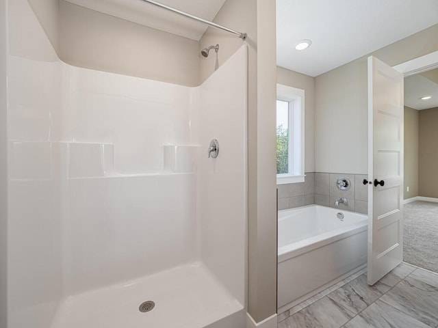 20713 Tamarack St NW, Oak Grove, MN 55011 - bathroom with a shower, a garden tub, marble look tiles, and baseboards
