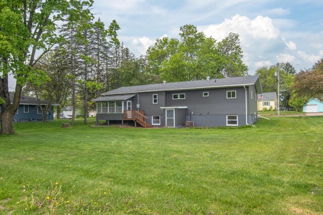 619 Aspen Ave S, Amery, WI 54001 - back of house with a sunroom, stairs, and a lawn