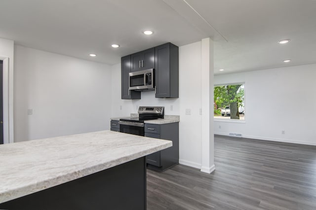 619 Aspen Ave S, Amery, WI 54001 - kitchen featuring stainless steel appliances, dark wood-style flooring, light countertops, recessed lighting, and baseboards