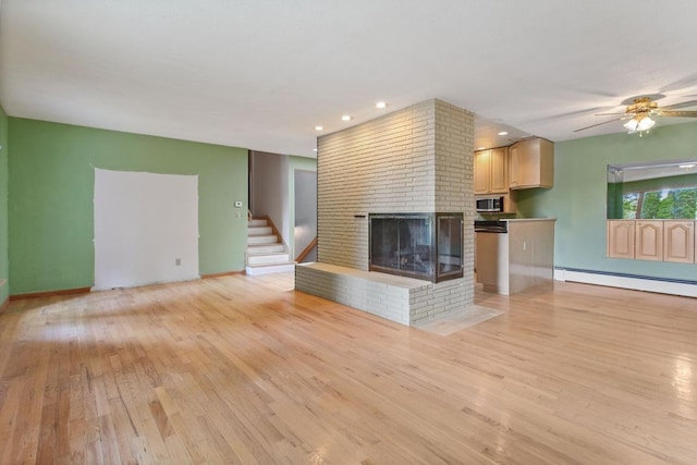 364 Owasso Blvd N, Shoreview, MN 55126 - unfurnished living room with baseboard heating, light wood-style floors, a ceiling fan, a brick fireplace, and recessed lighting