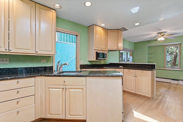 364 Owasso Blvd N, Shoreview, MN 55126 - kitchen featuring a peninsula, stainless steel microwave, a sink, a baseboard radiator, and light wood finished floors