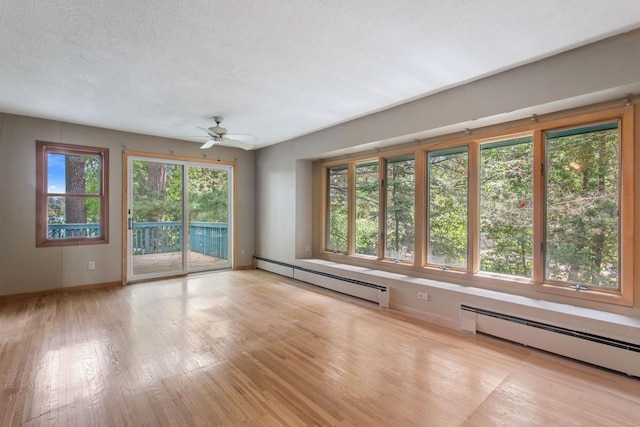 364 Owasso Blvd N, Shoreview, MN 55126 - unfurnished living room featuring a baseboard heating unit, baseboards, light wood-style floors, and ceiling fan