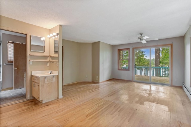 364 Owasso Blvd N, Shoreview, MN 55126 - unfurnished living room featuring a ceiling fan, light wood-style flooring, and baseboards