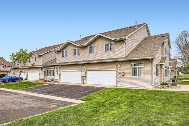 12729 Eagle St NW, Coon Rapids, MN 55448 - view of front of home with driveway, an attached garage, a front lawn, central air condition unit, and a residential view