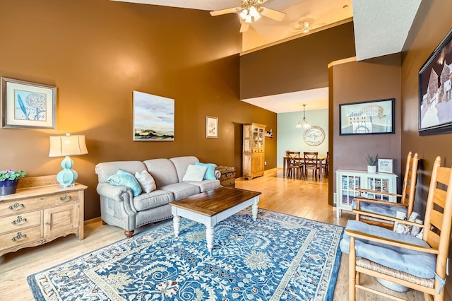 12729 Eagle St NW, Coon Rapids, MN 55448 - living area with wood finished floors, a ceiling fan, and a high ceiling