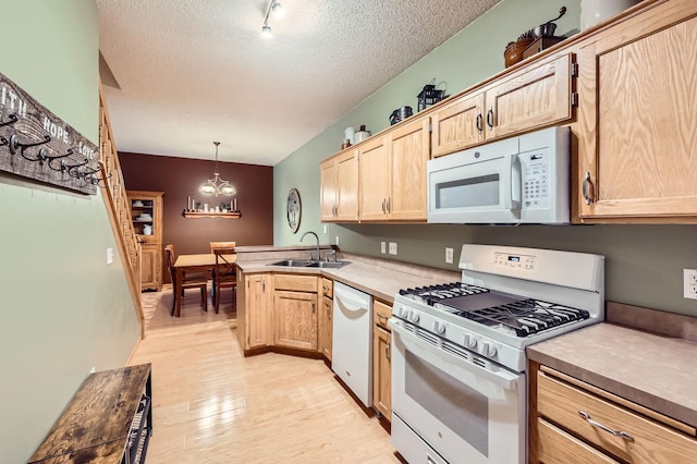 12729 Eagle St NW, Coon Rapids, MN 55448 - kitchen with white appliances, a sink, light brown cabinets, a textured ceiling, and light wood-type flooring