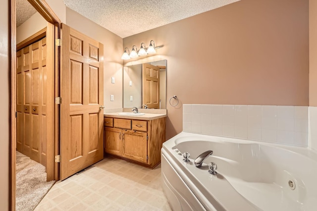 12729 Eagle St NW, Coon Rapids, MN 55448 - full bath with a textured ceiling, vanity, and a tub with jets
