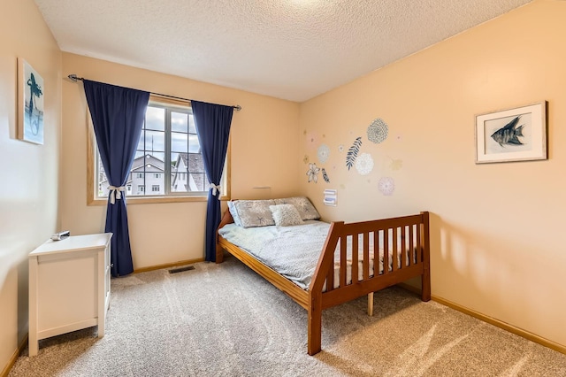 12729 Eagle St NW, Coon Rapids, MN 55448 - bedroom with carpet floors, a textured ceiling, and baseboards