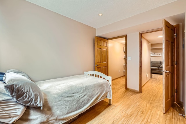 12729 Eagle St NW, Coon Rapids, MN 55448 - bedroom with light wood-style floors and baseboards