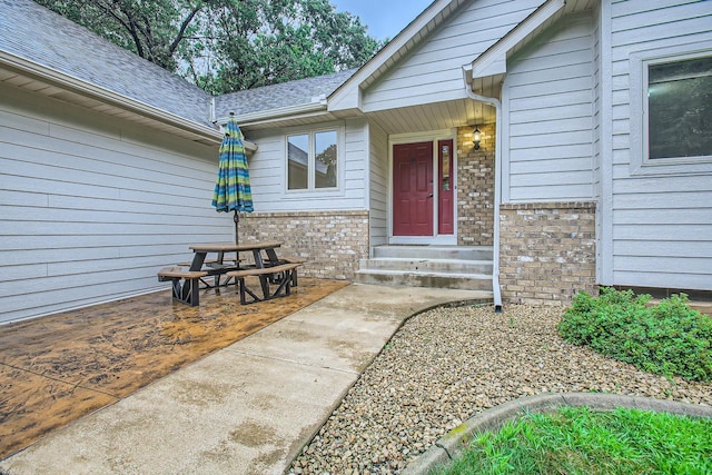701 Parkview Ln N, Champlin, MN 55316 - property entrance with brick siding and a shingled roof
