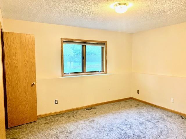 701 Parkview Ln N, Champlin, MN 55316 - unfurnished room featuring carpet, a textured ceiling, and baseboards