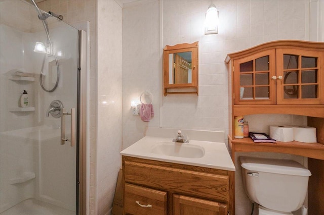 9298 Park Ave, Solon Springs, WI 54873 - bathroom featuring a stall shower, vanity, tile walls, and toilet