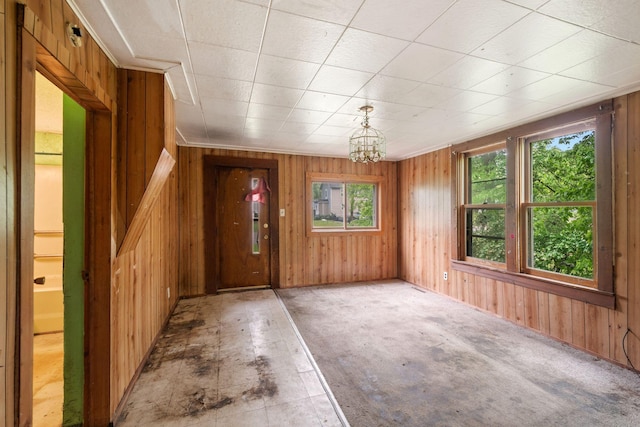 318 Austin Ave, Litchfield, MN 55355 - unfurnished dining area with wooden walls and a chandelier