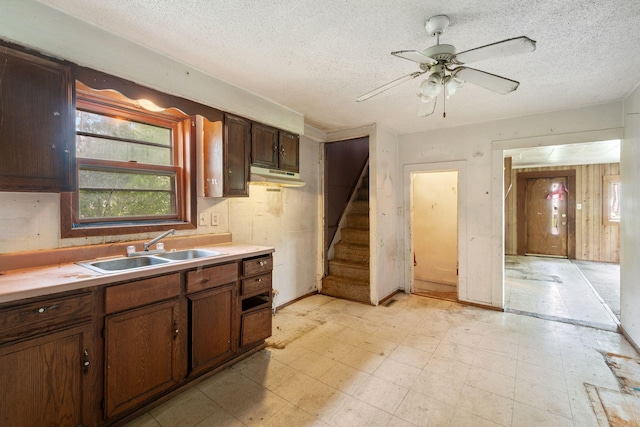 318 Austin Ave, Litchfield, MN 55355 - kitchen featuring a sink, a textured ceiling, light flooring, a ceiling fan, and light countertops