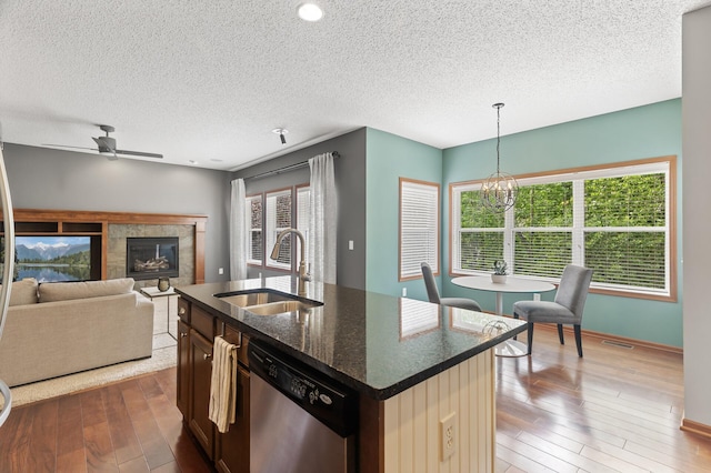4231 Maple Hurst Dr N, Rockford, MN 55373 - kitchen with dishwasher, a textured ceiling, a ceiling fan, a chandelier, and wood-type flooring