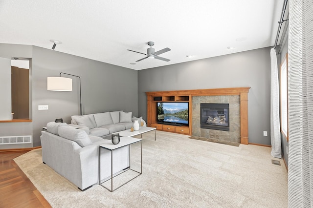 4231 Maple Hurst Dr N, Rockford, MN 55373 - living area with a ceiling fan, a tiled fireplace, and wood finished floors