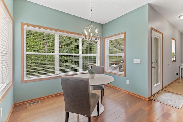 4231 Maple Hurst Dr N, Rockford, MN 55373 - dining room with a chandelier and wood finished floors