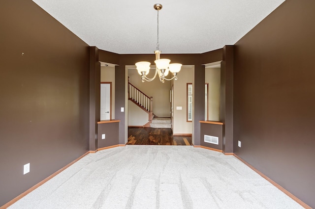 4231 Maple Hurst Dr N, Rockford, MN 55373 - carpeted spare room featuring a chandelier and stairs