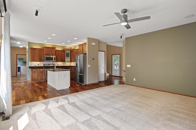 4231 Maple Hurst Dr N, Rockford, MN 55373 - kitchen with stainless steel appliances, washing machine and dryer, dark countertops, open floor plan, and recessed lighting